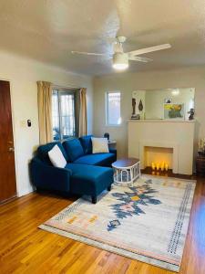a living room with a blue couch and a fireplace at Vintage charm vacation home with modern comforts near Old Town in Albuquerque
