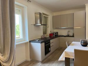 a small kitchen with a table and a window at Studio 55 in Aosta