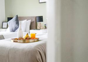 a hotel room with a tray of food on a bed at Walnut House - Close to City Centre - Free Parking, Fast Wifi and Smart TVs by Yoko Property in Milton Keynes