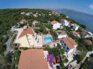 an aerial view of a house on a hill next to the water at Apartments Romana in Slatine