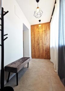 a room with a bench and a wooden door at PODWALE Apartment - Self Check-In 24h in Wrocław