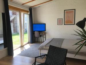 a bedroom with a bed and a tv on a wall at Tatsopus in Kamianets-Podilskyi