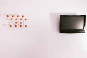 a tv on a white wall with a bunch of balls at The Hamlet Inn in Solvang