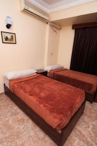 Postel nebo postele na pokoji v ubytování New Saint Catherine Hotel