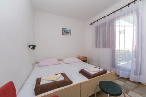 a bedroom with a bed with two towels on it at Apartments by the sea Podaca, Makarska - 516 in Podaca