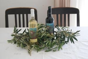 two bottles of wine sitting on a table with a plant at Apartment Zavala 553d in Jelsa +16 photos