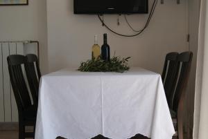 a white table with bottles of wine on it at Apartment Zavala 553d in Jelsa