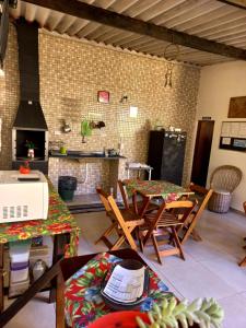 a room with a kitchen with a table and chairs at Suítes Cantinho do Sossego Ubatuba in Ubatuba