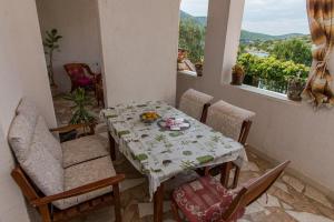 a dining room with a table and chairs and a window at Apartments by the sea Grebastica, Sibenik - 461 in Grebaštica