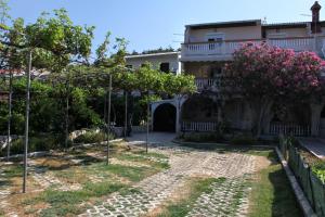 a house with a garden in front of it at Apartments by the sea Pag - 529 in Pag