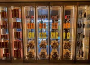 a refrigerator filled with lots of bottles of alcohol at Alevic Hotel Sirmione in Sirmione