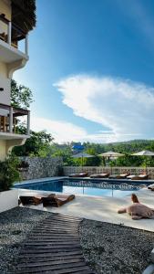 a swimming pool with a view of a building at Cabañas Sicarú Mazunte in Mazunte