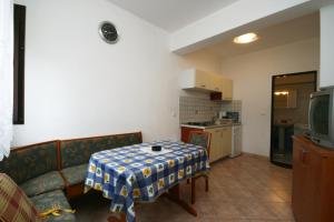 a living room with a couch and a table at Apartment Vantacici 427d in Malinska