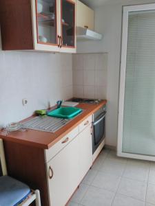 a kitchen with a sink and a counter top at Apartments by the sea Sali, Dugi otok - 444 in Sali