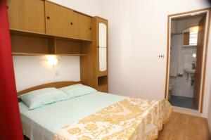 a small bedroom with a bed and a bathroom at Single Room Zavalatica 547f in Zavalatica