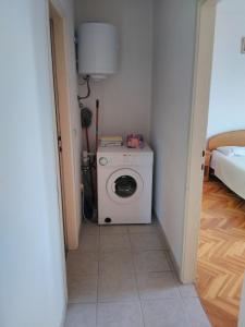 a bathroom with a washing machine in a room at Apartments by the sea Sali, Dugi otok - 444 in Sali