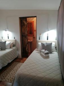 a bedroom with two beds and a mirror at African Elephant's Den in Klerksdorp