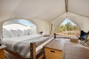 a bedroom with a bed in a tent at Under Canvas Grand Canyon in Valle
