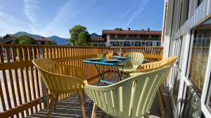 a table and chairs sitting on a balcony at Pia am See - Bio Design Appartement in Bad Wiessee