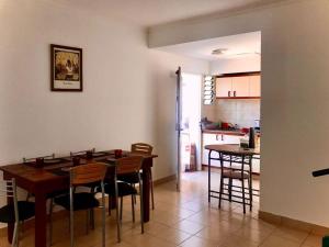 a kitchen and dining room with a table and chairs at Duplex Gral .Viamonte 27- Tandil in Tandil