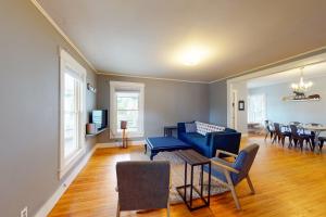 a living room with a blue couch and a table at The General in Lowell