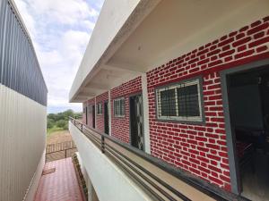 an empty balcony of a brick building with a window at Fulgulab Lawns and Home Stay in Junnar