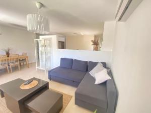 a living room with a blue couch and a table at מול האגם in Ma'alot Tarshiha