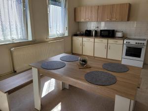 a kitchen with a wooden table with four rugs on it at Große Monteurwohnung oder Fewo bei Nina in Bad Grund