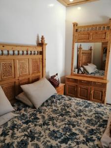 Tourist Guest House في Anīahgrām: غرفة نوم بسرير ومرآة كبيرة