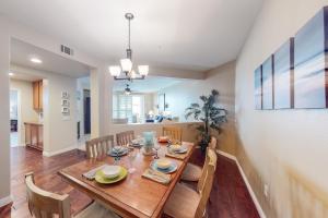 a dining room with a wooden table and chairs at Ocean Pointe Lagoon #107 in Carlsbad