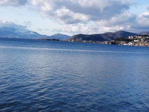 a large body of water with mountains in the background at Apartment NAUM M in Ohrid