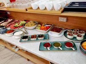 a table with many dishes of food on it at Betlemi Hotel in Tbilisi City