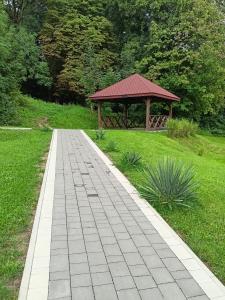 a walkway leading to a gazebo in a park at Apartament Blondynka Miasto Soli Bochnia in Bochnia