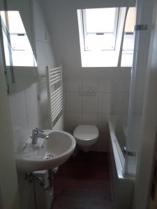 a bathroom with a sink and a toilet and a window at Haus am Mühlenkämpchen - Schönblick in Radevormwald