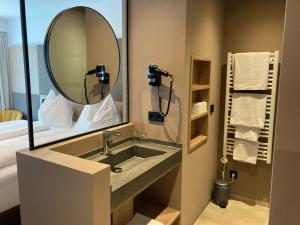 a bathroom with a sink and a mirror at Obstgarten Gästehaus in Hollenstein an der Ybbs