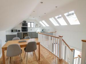 a kitchen and dining room with a table and chairs at Lifford Coach House in Sutton upon Trent