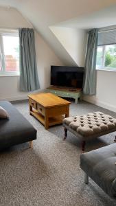 a living room with a couch and a coffee table at Bexhill Sea View Flat 3 in Bexhill