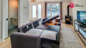 sala de estar con sofá y chimenea en La Marie-Clémentine de Portneuf / Private hot tub, Pool & Billard, en Pont-Rouge