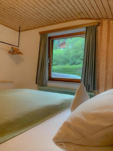a bedroom with a bed and a window at Landhaus Gappmaier in Zell am See