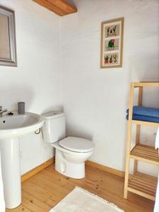 a bathroom with a toilet and a sink at Casa Salitre in Famara