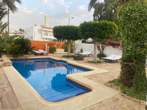 a swimming pool in the middle of a yard at Villa Playa Mojacar in Mojácar