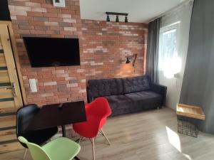 Televízia a/alebo spoločenská miestnosť v ubytovaní Loft House