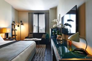 a bedroom with a large bed and a large window at SIXTY SoHo in New York
