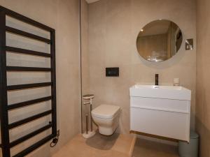 a bathroom with a white toilet and a mirror at 13 Cliff Edge in Newquay +23 photos