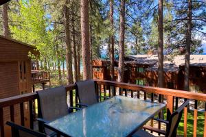a table and chairs on the deck of a cabin at Tahoe Enchantment in Zephyr Cove