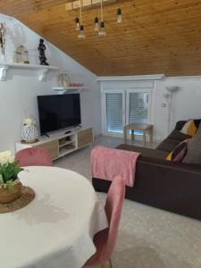 a living room with a couch and a table at Apartamento MARIÑA SANXENXO in Sanxenxo