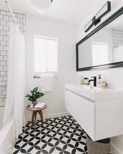 a white bathroom with a sink and a mirror at Spotless Modern Home Close to LAX & Sofi Stadium in Inglewood