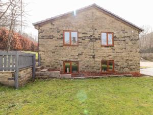 a brick house with windows in a yard at Canal View in Todmorden