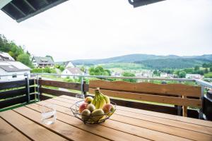 a bowl of fruit on a table on a balcony at Auszeit im Schwarzwald in Lenzkirch