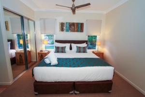 a hotel room with a bed and a dresser at Edge on Beaches in Agnes Water